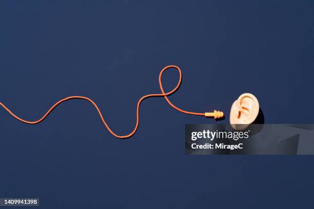 sound insulation earplugs for ear protection - listening concept stock pictures, royalty-free photos & images