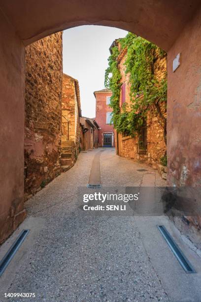 street view of the small town of roussillon, the red clay city in provence, south france - vaucluse stock pictures, royalty-free photos & images