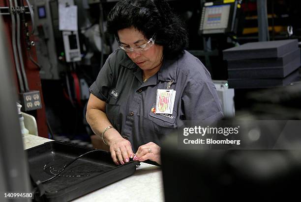 Worker installed an o-ring in an injection-molded plastic hardshell case at the Pelican Products Inc. Production facility in Torrance, California,...