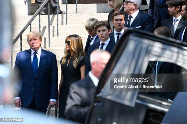 Former President Donald J. Trump, Melania Trump, and Barron Trump exit the funeral of Ivana Trump at St. Vincent Ferrer Roman Catholic Church July...