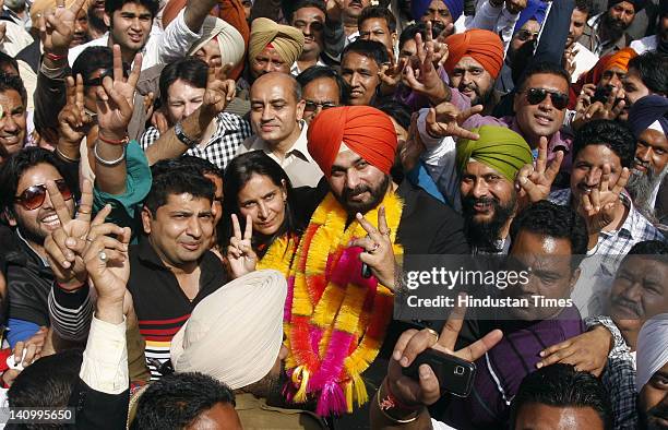 Amritsar MP Navjot Singh Sidhu, along with his wife and newly elected BJP MLA from Amritsar east Navjot Kaur Sidhu, celebrate the notable performance...