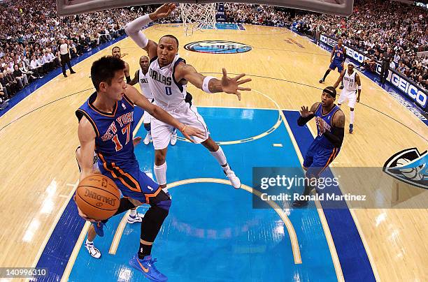 Jeremy Lin of the New York Knicks passes the ball against Shawn Marion of the Dallas Mavericks at American Airlines Center on March 6, 2012 in...