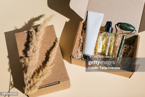 beauty box with face and body care products on beige background. - package design stock-fotos und bilder