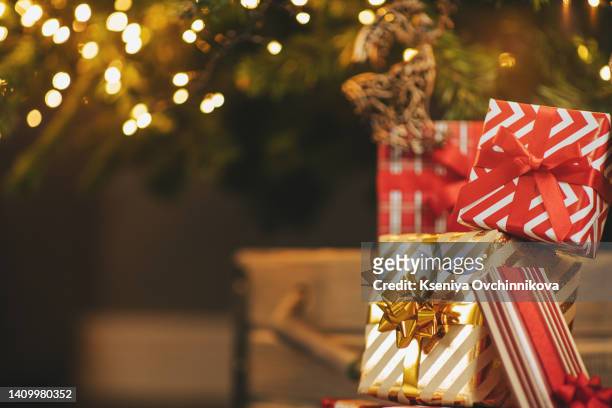 beautiful christmas gifts under fir tree on floor in room - christmas presents under tree stock pictures, royalty-free photos & images