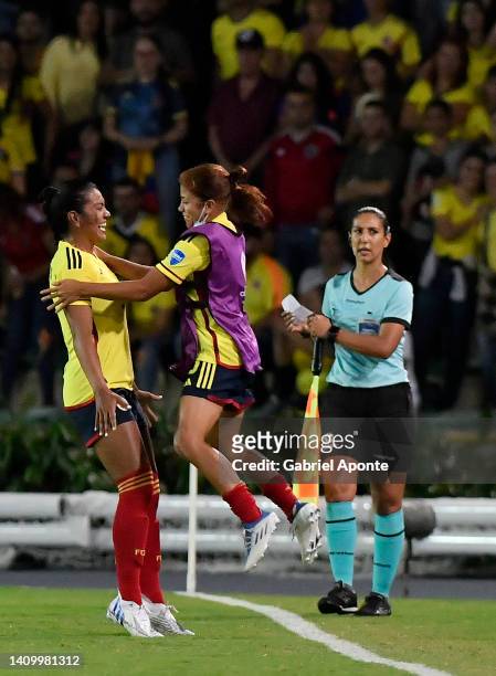 Daniela Alexandra Arias Rojas of Colombia celebrates with teammate after scoring the second goal of her team during a match between Colombia and...