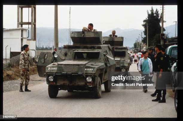 Armored personnel carriers move through an area where hundreds were killed October 22, 1997 in Rais, Algeria. Angered by the suppression of the...