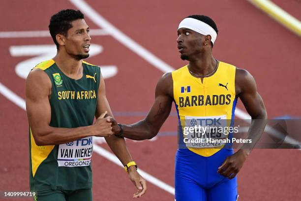 Wayde van Niekerk of Team South Africa shakes hands with Jonathan Jones of Team Barbados following the Men's 400m Semi-Final on day six of the World...