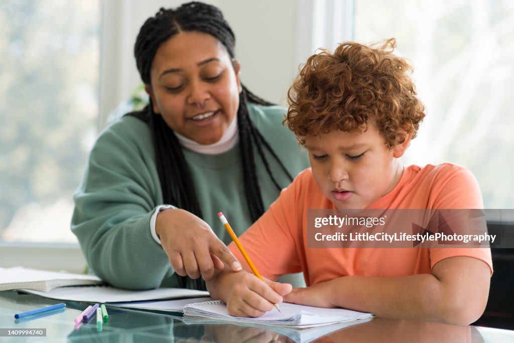 Mother Gently Correcting Her Sons Homework