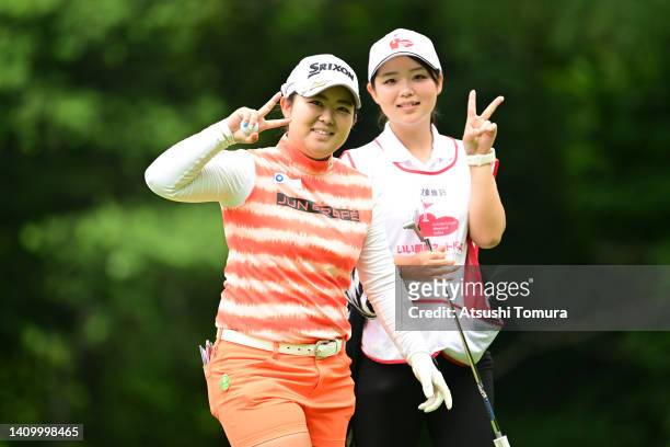 Saki Asai of Japan poses after the birdie with her sister and caddie Miki on the 12th green during the first round of Daito Kentaku eHeyanet Ladies...