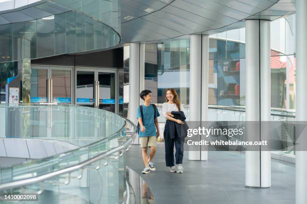 mother took her asian son home. - pedestrian overpass stock pictures, royalty-free photos & images