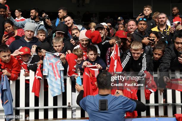 Supporters look to get an autograph from Bruno Fernandes of Manchester United during a Manchester United training session at the WACA on July 21,...