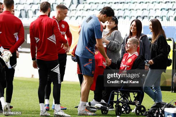 Harry Maguire of Manchester United greet Danny Hodgson during a Manchester United training session at the WACA on July 21, 2022 in Perth, Australia.