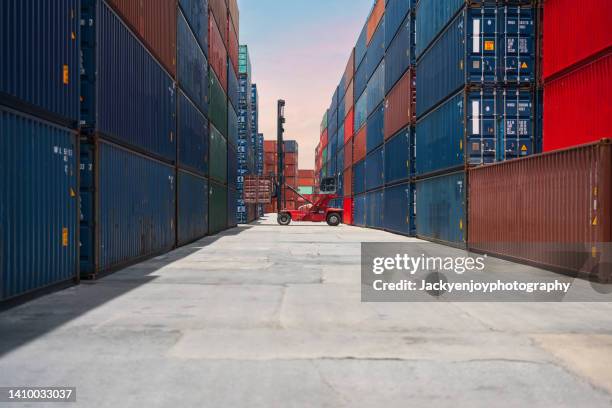 crane lifting up container in yard - box lifting technique stock-fotos und bilder