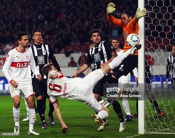 Georg Niedermeier of Stuttgart tries to score against goalkeeper Tobias Sippel of Kaiserslautern during the Bundesliga match between VfB Stuttgart...