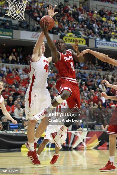 Victor Oladipo of the Indiana Hoosiers drives for a first half shot attempt against Jared Berggren of the Wisconsin Badgers during their quarterfinal...
