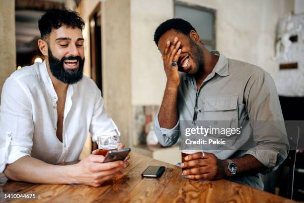 friends enjoying beer in a restaurant - italy beer stock pictures, royalty-free photos & images