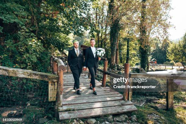 gay couple walking together after the bride - civil partnership stock pictures, royalty-free photos & images