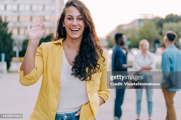 cheerful woman walking in the city. - female waving on street stock pictures, royalty-free photos & images