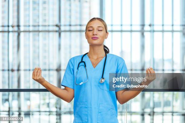 beautiful young nurse woman wearing uniform and stethoscope at the clinic relax and smiling with eyes closed doing meditation gesture with fingers. - nurse meditating stock pictures, royalty-free photos & images