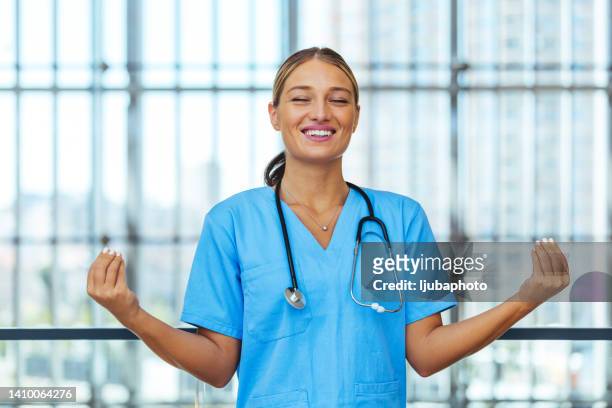 nurse meditating with eyes closed - nurse meditating stock pictures, royalty-free photos & images