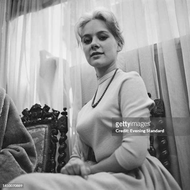 Low angle view of British actress Francesca Annis wearing a white sweater with a beaded necklace, United Kingdom, 25th January 1962.