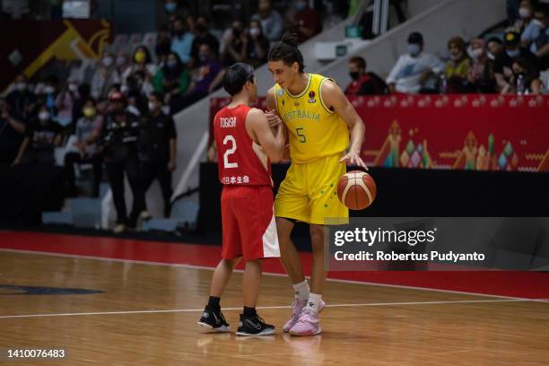 Tyrese Proctor of Australia shakes hand Yuki Togashi of Japan during the FIBA Asia Cup quarter-final between Australia and Japan at Istora Gelora...