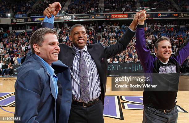 Sacramento mayor Kevin Johnson and owners Joe Maloof and Gavin Maloof of the Sacramento Kings join hands as they address the fans in attendence of...