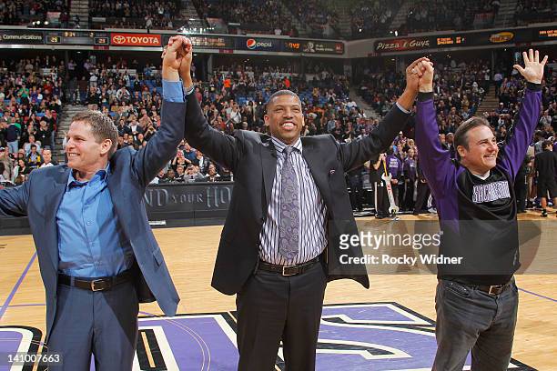 Sacramento mayor Kevin Johnson and owners Joe Maloof and Gavin Maloof of the Sacramento Kings join hands as they address the fans in attendence of...