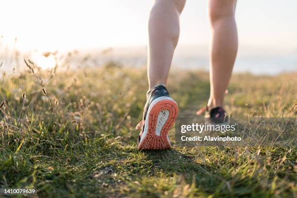 close up of sneakers in the countryside - 足下 ストックフォトと画像