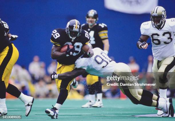 Barry Foster, Running Back for the Pittsburgh Steelers runs the football as James Williams, Linebacker for the New Orleans Saints attempts to tackle...