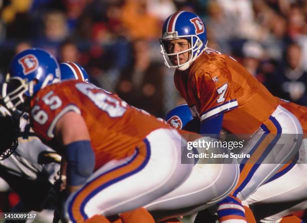 John Elway, Quarterback for the Denver Broncos calls the play on the line of scrimmage during the American Football Conference West game against the...