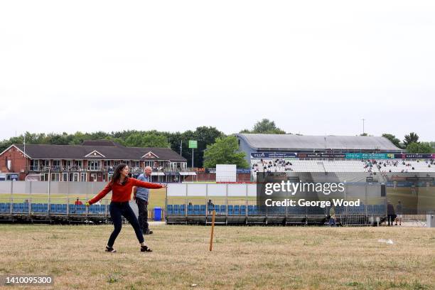 Spectators play a game of Cricket on a field beside the stadium during the LV= Insurance County Championship match between Derbyshire and...