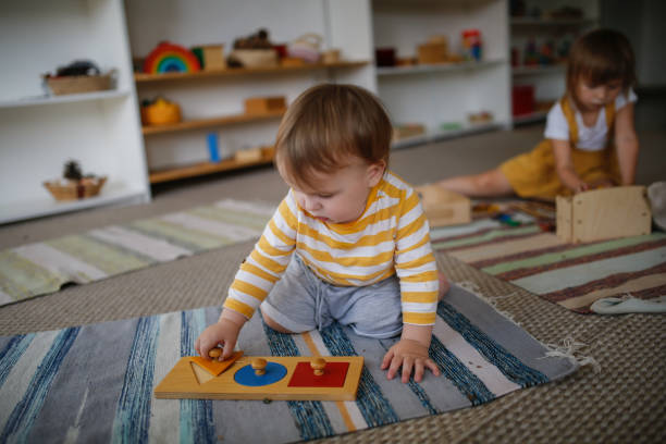 young child playing with a small puzzle