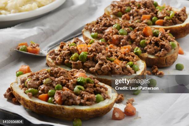 preparing twice baked potato shepherd's pie - stuffed potato stock pictures, royalty-free photos & images