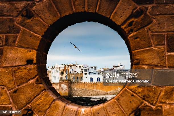 essaouira at sunset from porthole, morocco - african cityscape stockfoto's en -beelden