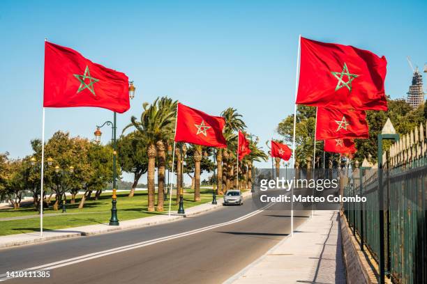 road with flags of morocco in rabat - rabat morocco ストックフォトと画像