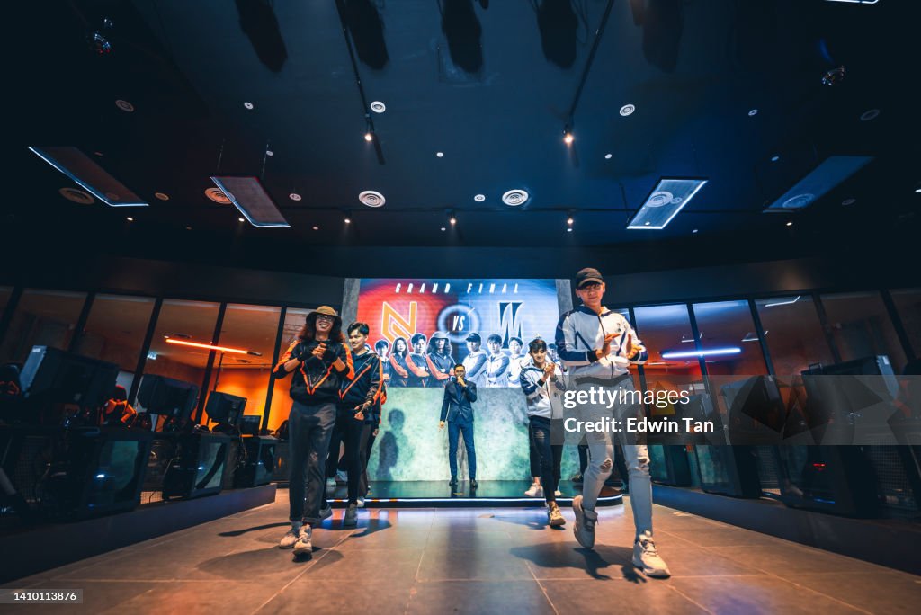 Asian Emcee Game show host introducing grand final esports team players on stage