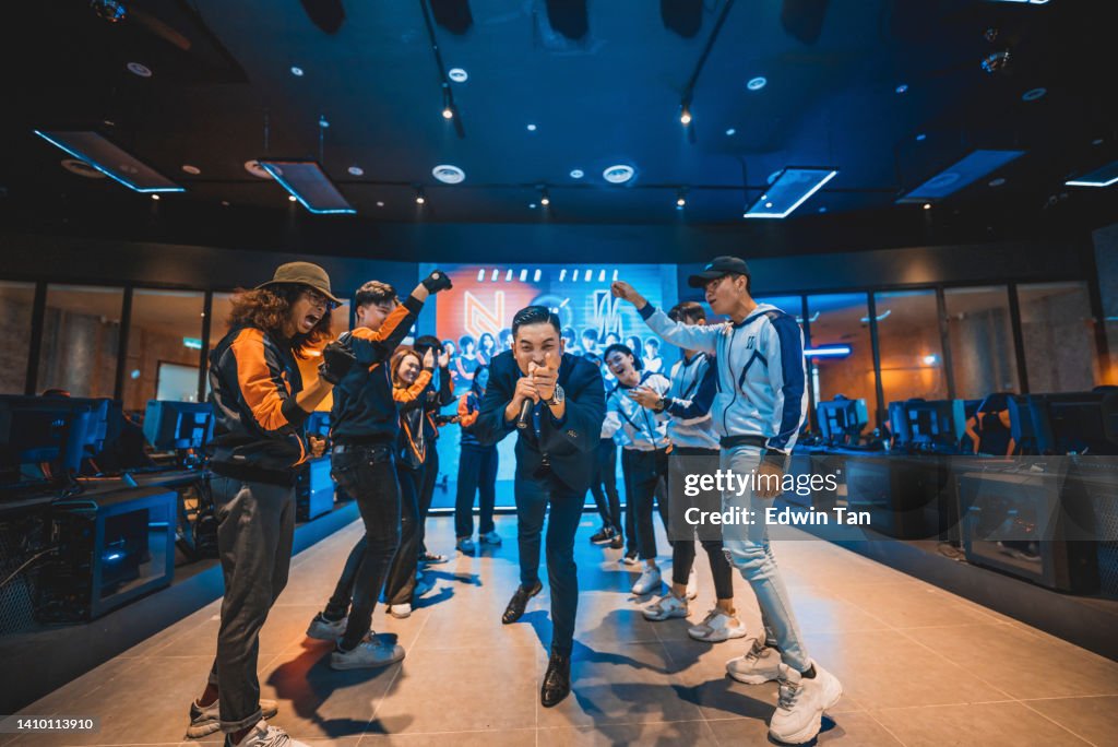 Asian Emcee Game show host introducing grand final esports team players on stage
