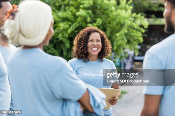 colleagues gather in the community park - volunteer stock pictures, royalty-free photos & images