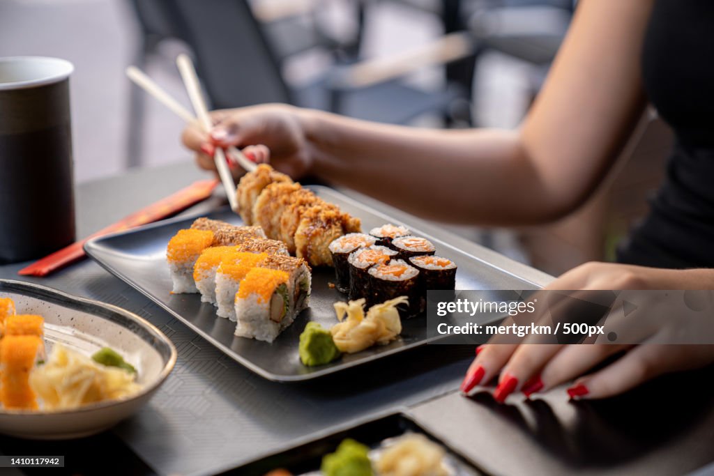 Cropped hands of woman holding sushi in plate on table,Turkey