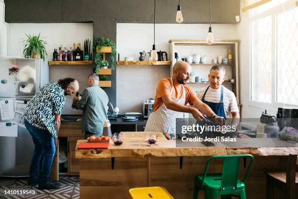 gay couples cooking in a kitchen - gay couple cooking stock pictures, royalty-free photos & images