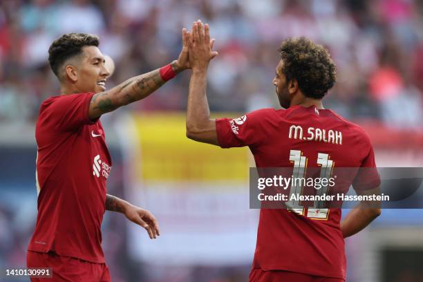 Mohamed Salah celebrates with Roberto Firmino of Liverpool after scoring their team's first goal during the pre-season friendly match between RB...