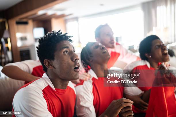 sports friends fans watching a match at a house - fifa world cup pre tournament stock pictures, royalty-free photos & images