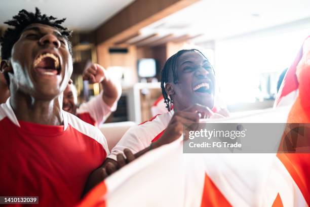 freunde porträtieren fans, die feiern, während sie ein spiel zu hause sehen - chl-kanadische-eishockey-liga stock-fotos und bilder