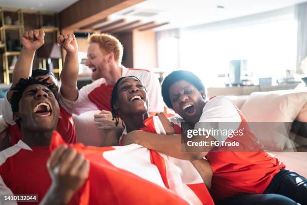 friends ports fans celebrating while watching a match at home - hockey black white stock pictures, royalty-free photos & images