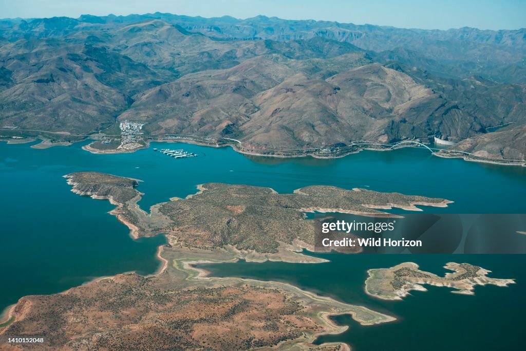 High aerial view of Theodore Roosevelt Lake, bridge, dam, and the Salt River in the canyons below