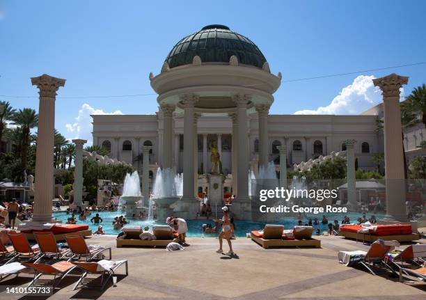 People cool off in the 110 degree heat at Temple Pool, one of seven pools at the Caesars Palace Garden of the Gods Pool Oasis, as viewed on July 15,...