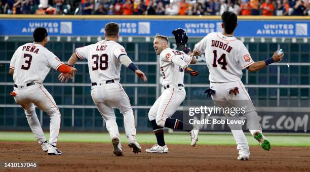 Matijevic of the Houston Astros celebrates with his teammates after hitting a walk-off single against the New York Yankees during game one of a...