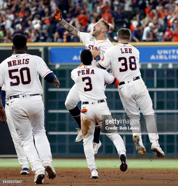 Matijevic of the Houston Astros celebrates with his teammates after hitting a walk-off single against the New York Yankees during game one of a...