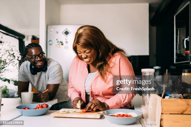 couple preparing breakfast together - woman laugh cook stock pictures, royalty-free photos & images